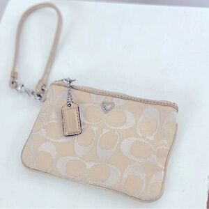 Coach Poppy Wristlet. Cream and Gold Canvas Logo Print with Pink Satin interior.
